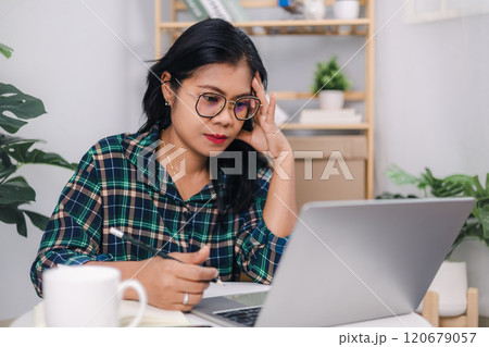 Businesswoman working in home or small office with using a laptop. Close up shot hands of freelancer use laptop working on desk of her this is a lifestyle of freelance or editor. Businesswoman working in home or small office with using a laptop. Close up shot hands of freelancer use laptop working on desk of her this is a lifestyle of freelance or editor. 120679057