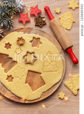 Preparing christmas cookies with dough, cutters, and festive decorations Preparing christmas cookies with dough, cutters, and festive decorations 120680302