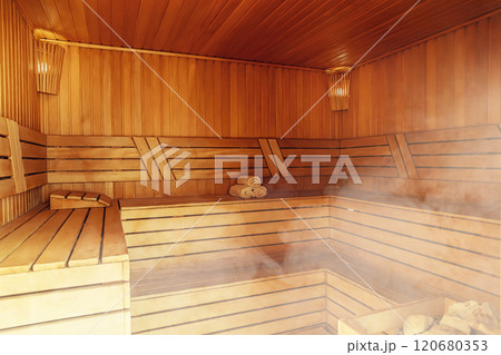 Interior of Finnish sauna, classic wooden sauna with hot steam. Russian bathroom. Relax in hot sauna with steam. Wooden interior baths, wooden benches and loungers accessories for sauna, spa complex Interior of Finnish sauna, classic wooden sauna with hot steam. Russian bathroom. Relax in hot sauna with steam. Wooden interior baths, wooden benches and loungers accessories for sauna, spa complex 120680353