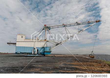 Walking excavator working at coal mine. Dragline Excavator Loads Soil, Clay. Work Walking Excavator In Open Pit. Working Heavy Machinery. Working on construction site 120680360