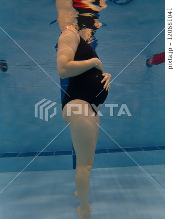 Pregnant Woman Underwater in Swimming Pool Pregnant Woman Underwater in Swimming Pool 120681041