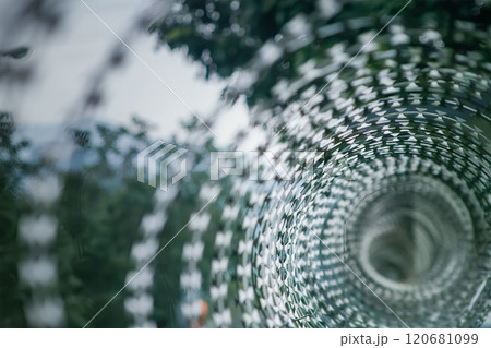 Intricate Spiral of Razor Wire with Geometric Patterns. Intricate Spiral of Razor Wire with Geometric Patterns. 120681099
