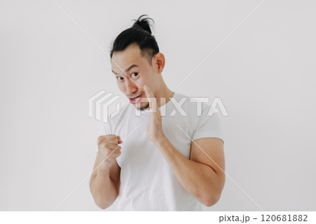 Funny tricky face man telling secret in white t-shirt isolate on white. 120681882