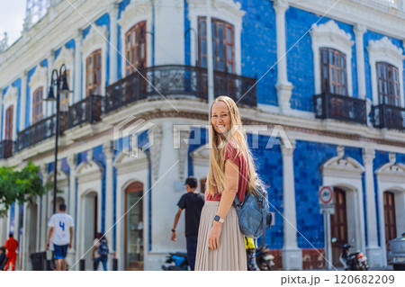 Female tourist in front of Casa de los Azulejos in Villahermosa, Mexico. Quintana Roo travel, cultural exploration, and historic architecture concept Female tourist in front of Casa de los Azulejos in Villahermosa, Mexico. Quintana Roo travel, cultural exploration, and historic architecture concept 120682209