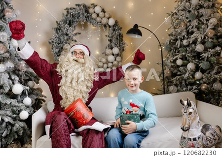 Santa claus giving christmas gift to a happy child 120682230
