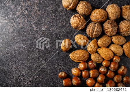 Mix of nuts on dark background. Almonds, hazelnuts, walnuts. Top view. Mix of nuts on dark background. Almonds, hazelnuts, walnuts. Top view. 120682481