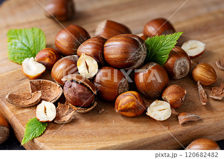Hazelnuts pile on a wooden board Hazelnuts pile on a wooden board 120682482