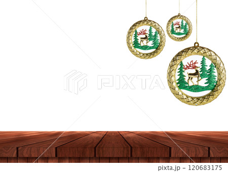 Christmas ornaments hanging beautifully over a rustic wooden table 120683175