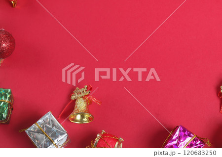 Festive Christmas decorations on a vibrant red background with copy space, Top view 120683250