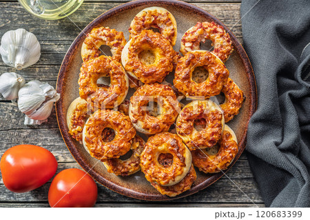 Mini pizza bagels on plate on wooden table. Top view. Mini pizza bagels on plate on wooden table. Top view. 120683399