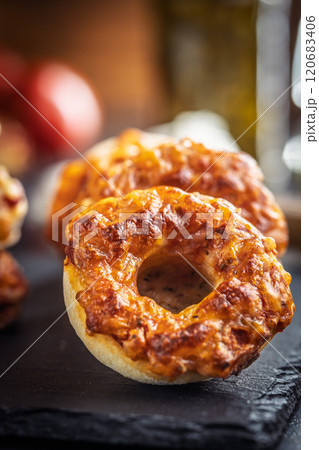 Mini pizza bagels on cutting board on black table. 120683406