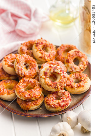 Mini pizza bagels on plate on white table. Mini pizza bagels on plate on white table. 120683408