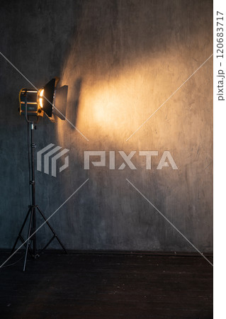 Lighting fixture shines of a dark photo studio Lighting fixture shines of a dark photo studio 120683717