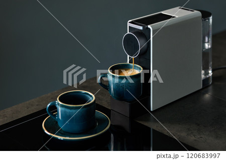 Coffee Machine Brewing Espresso into Stylish Blue Cups 120683997