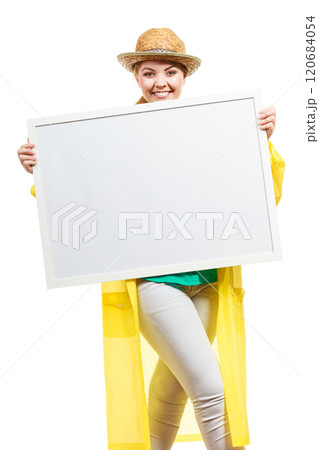 Happy cheerful woman holding blank white board Happy cheerful woman holding blank white board 120684054