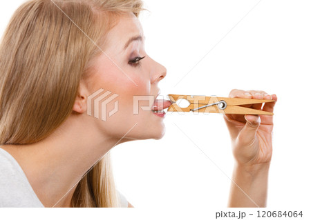 Blonde woman having tongue in clothespin 120684064