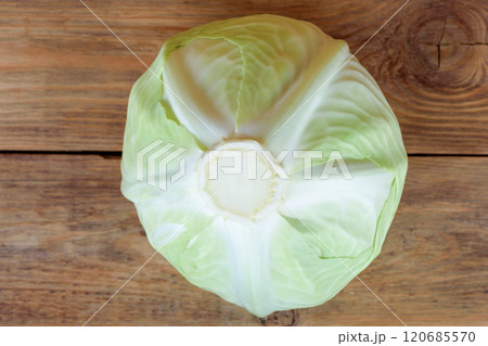 Top view of white cabbage on wooden background. 120685570