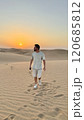 A serene man in the vast desert, a peaceful Sunset 120685812