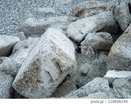 A pile of broken concrete. Cement lumps. Building material on the seashore. A pile of broken concrete. Cement lumps. Building material on the seashore. 120686240