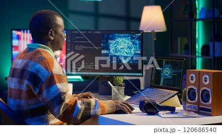 African american IT professional managing AI system for machine learning, coding software on terminal window. Futuristic interface program focuses on cybersecurity, networking for database. Camera A. African american IT professional managing AI system for machine learning, coding software on terminal window. Futuristic interface program focuses on cybersecurity, networking for database. Camera A. 120686540