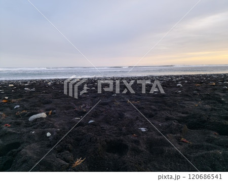 Ocean shoreline with black sand beach, spectacular panoramic view of nature and wilderness with waves crashing on beachfront. Frozen coastline in Iceland with wonderful scenery and rocks. Ocean shoreline with black sand beach, spectacular panoramic view of nature and wilderness with waves crashing on beachfront. Frozen coastline in Iceland with wonderful scenery and rocks. 120686541