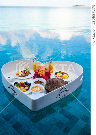 Floating breakfast in a heart shape in the pool in Maldives Floating breakfast in a heart shape in the pool in Maldives 120687279