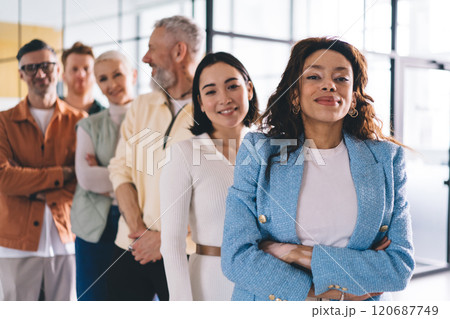 Half length portrait of African American businesswoman looking at camera and feeling proud of successful team Half length portrait of African American businesswoman looking at camera and feeling proud of successful team 120687749