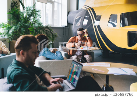 Diverse coworkers working in modern workspace Diverse coworkers working in modern workspace 120687766