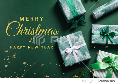 Merry Christmas and New Year, green gift boxes on green background with text top view Merry Christmas and New Year, green gift boxes on green background with text top view 120690469