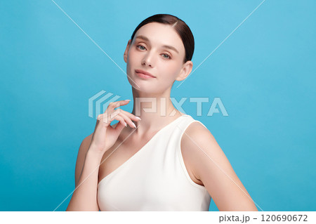 Beautiful young woman with clean fresh skin on blue background, Face care, Facial treatment, Cosmetology, beauty and spa, women portrait. Beautiful young woman with clean fresh skin on blue background, Face care, Facial treatment, Cosmetology, beauty and spa, women portrait. 120690672