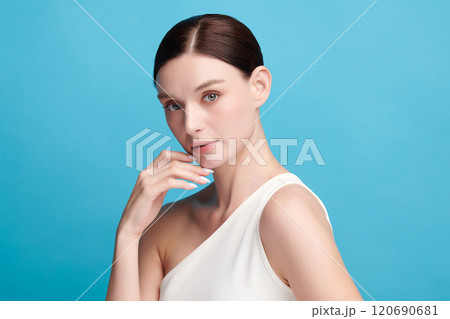 Beautiful young woman with clean fresh skin on blue background, Face care, Facial treatment, Cosmetology, beauty and spa, women portrait. 120690681
