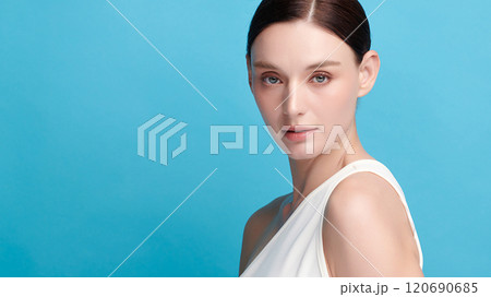 Beautiful young woman with clean fresh skin on blue background, Face care, Facial treatment, Cosmetology, beauty and spa, women portrait. Beautiful young woman with clean fresh skin on blue background, Face care, Facial treatment, Cosmetology, beauty and spa, women portrait. 120690685