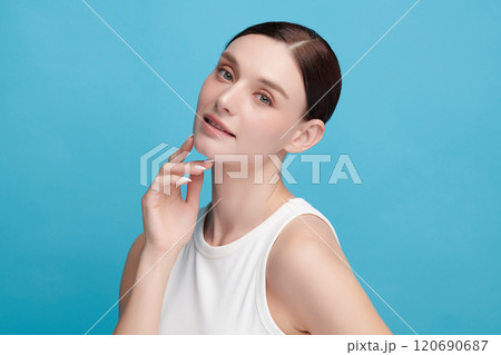 Beautiful young woman with clean fresh skin on blue background, Face care, Facial treatment, Cosmetology, beauty and spa, women portrait. Beautiful young woman with clean fresh skin on blue background, Face care, Facial treatment, Cosmetology, beauty and spa, women portrait. 120690687