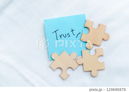 Building business trust puzzle pieces symbolizing connection office setting visual content minimalist environment close-up conceptual understanding Building business trust puzzle pieces symbolizing connection office setting visual content minimalist environment close-up conceptual understanding 120690878
