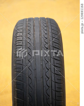 Vehicle maintenance inspecting tire tread depth garage workshop technical guide indoor setting close-up safety awareness Vehicle maintenance inspecting tire tread depth garage workshop technical guide indoor setting close-up safety awareness 120691168