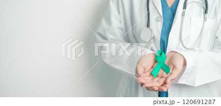 Doctor holding Teal Ribbon for January Cervical Cancer Awareness month. Uterus and Ovaries, Cervix, Endometriosis, Hysterectomy, Uterine fibroids, Reproductive, Healthcare and World cancer day 120691287
