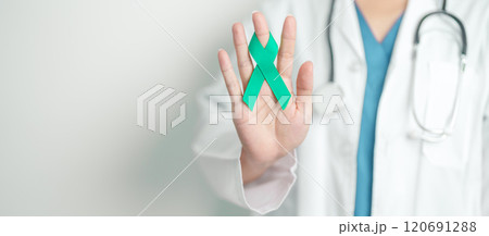 Doctor holding Teal Ribbon for January Cervical Cancer Awareness month. Uterus and Ovaries, Cervix, Endometriosis, Hysterectomy, Uterine fibroids, Reproductive, Healthcare and World cancer day 120691288