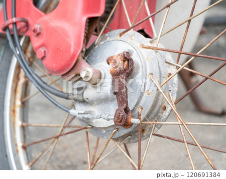 Motorcycle wheel hub close-up workshop industrial photography mechanic environment detailed view engineering concept 120691384