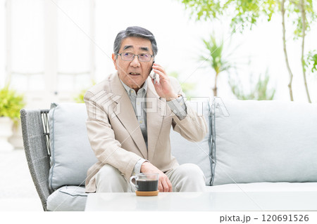 スマートフォンで会話するシニア男性 120691526