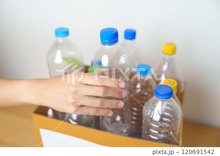 Volunteer keep plastic bottle into paper box at home or office. Hand Sorting Recycle garbage. Ecology, Environmental, pollution, Dispose recycling, waste management and trash Separation concept Volunteer keep plastic bottle into paper box at home or office. Hand Sorting Recycle garbage. Ecology, Environmental, pollution, Dispose recycling, waste management and trash Separation concept 120691542