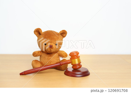 Children, Kid and Family Law concepts. toy bear with gavel justice hammer on desk in courthouse. 120691708