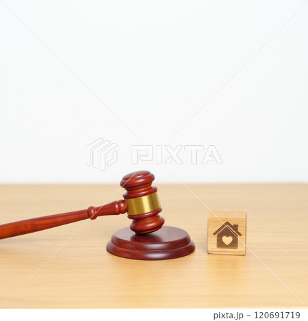 Family Law, Real Estate, Home, property Tax, Auction and Bidding concepts. small toy house model with gavel justice hammer on desk in courthouse. Family Law, Real Estate, Home, property Tax, Auction and Bidding concepts. small toy house model with gavel justice hammer on desk in courthouse. 120691719