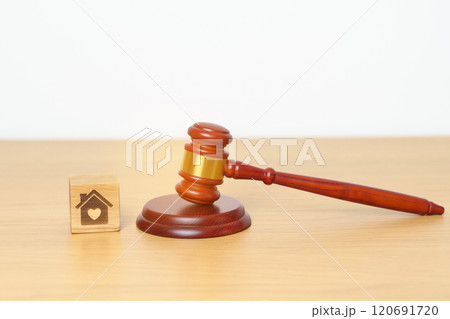 Family Law, Real Estate, Home, property Tax, Auction and Bidding concepts. small toy house model with gavel justice hammer on desk in courthouse. Family Law, Real Estate, Home, property Tax, Auction and Bidding concepts. small toy house model with gavel justice hammer on desk in courthouse. 120691720