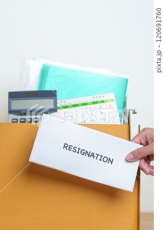 Resignation, Layoff, Unemployment, Dismiss, Job quit, Jobless and Farewell concept. Businessman holding letter of Resign contract with documents cardboard box at office 120691760
