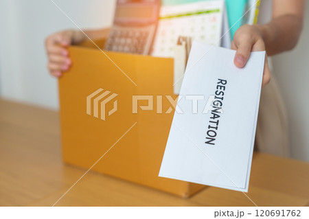 Resignation, Layoff, Unemployment, Dismiss, Job quit, Jobless and Farewell concept. Businesswoman holding letter of Resign contract with documents cardboard box at office Resignation, Layoff, Unemployment, Dismiss, Job quit, Jobless and Farewell concept. Businesswoman holding letter of Resign contract with documents cardboard box at office 120691762