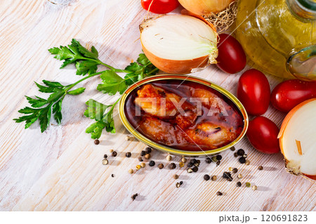 Stuffed squid in tomato sauce on background with greens, tomatoes 120691823