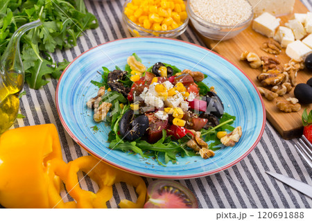 Salad with arugula, olives, Feta cheese, corn and walnut and its ingredients 120691888