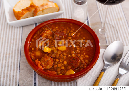 Stewed lentils with sausages, spanish Riojan lentils 120691925