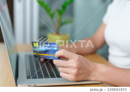 woman hand holding credit card and using laptop for online shopping while making order at home. Marketplace platform website, technology, ecommerce, digital banking and online payment concept woman hand holding credit card and using laptop for online shopping while making order at home. Marketplace platform website, technology, ecommerce, digital banking and online payment concept 120691933