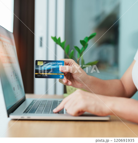 woman hand holding credit card and using laptop for online shopping while making order at home. Marketplace platform website, technology, ecommerce, digital banking and online payment concept woman hand holding credit card and using laptop for online shopping while making order at home. Marketplace platform website, technology, ecommerce, digital banking and online payment concept 120691935